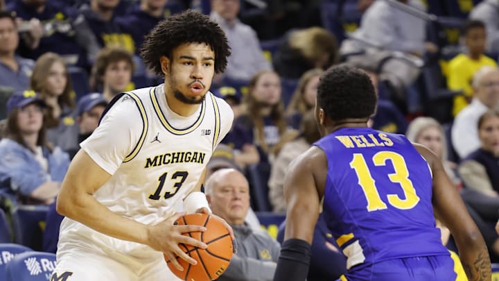 Dec 29, 2023; Ann Arbor, Michigan, USA;  Michigan Wolverines forward Olivier Nkamhoua (13) is