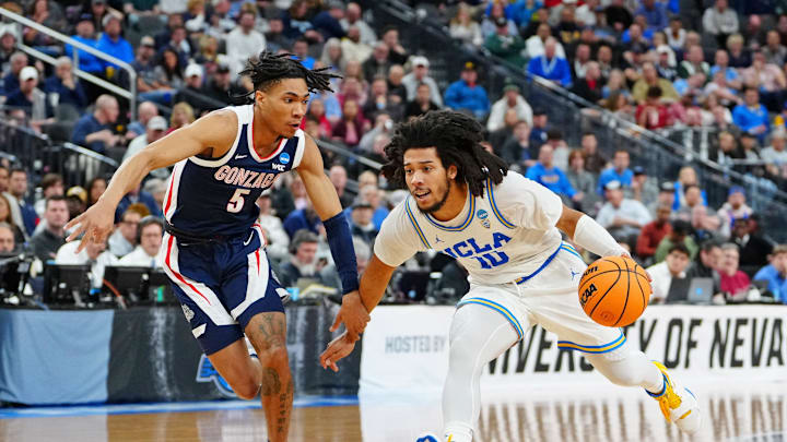 Mar 23, 2023; Las Vegas, NV, USA; UCLA Bruins guard Tyger Campbell (10) dribbles the ball against Gonzaga Bulldogs guard Hunter Sallis (5) during the first half at T-Mobile Arena. Mandatory Credit: Stephen R. Sylvanie-Imagn Images