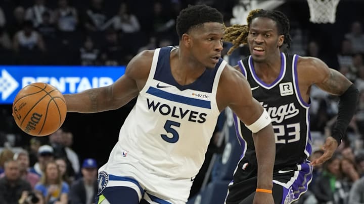 Feb 3, 2025; Minneapolis, Minnesota, USA; Minnesota Timberwolves guard Anthony Edwards (5) moves past Sacramento Kings guard Keon Ellis (23) in the first quarter at Target Center. Mandatory Credit: Bruce Kluckhohn-Imagn Images