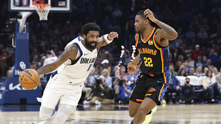 Nov 17, 2024; Oklahoma City, Oklahoma, USA; Dallas Mavericks guard Kyrie Irving (11) drives around Oklahoma City Thunder guard Cason Wallace (22) during the second quarter at Paycom Center. Mandatory Credit: Alonzo Adams-Imagn Images Nov 17, 2024; Oklahoma City, Oklahoma, USA; Dallas Mavericks guard Kyrie Irving (11) drives around Oklahoma City Thunder guard Cason Wallace (22) during the second quarter at Paycom Center. Mandatory Credit: Alonzo Adams-Imagn Images