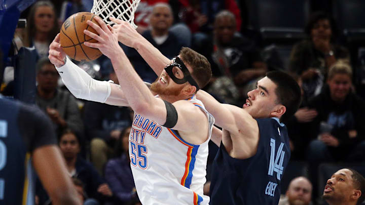 Mar 5, 2025; Memphis, Tennessee, USA; Oklahoma City Thunder center Isaiah Hartenstein (55) and Memphis Grizzlies center Zach Edey (14) battle for a rebound during the second quarter at FedExForum. Mandatory Credit: Petre Thomas-Imagn Images