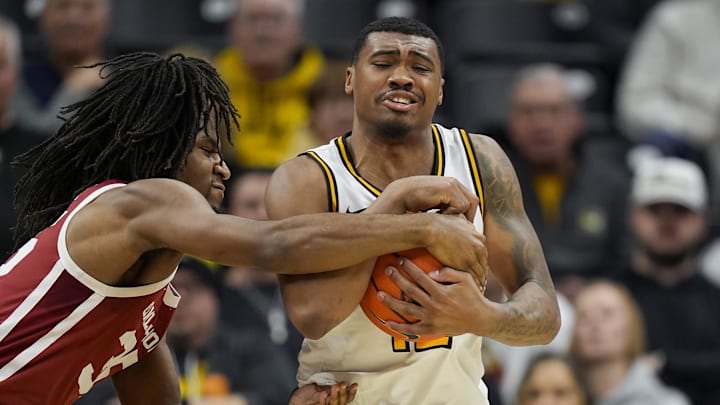 Feb 12, 2025; Columbia, Missouri, USA; Missouri Tigers guard Tony Perkins (12) and Oklahoma Sooners forward Glenn Taylor Jr. (35) fight for a loose ball during the second half at Mizzou Arena. Mandatory Credit: Jay Biggerstaff-Imagn Images