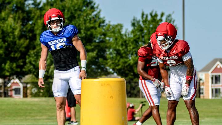 Oklahoma quarterback John Mateer prepares to take a snap next to Lloyd Avant during practice.
