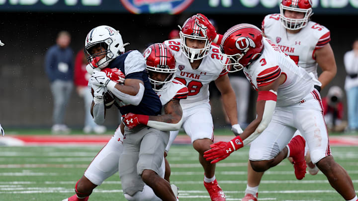 Nov 18, 2023; Tucson, Arizona, USA; Arizona Wildcats running back Rayshon Luke (21) runs the ball against Utah Utes cornerback JaTravis Broughton (4) during the second half at Arizona Stadium. Mandatory Credit: Zachary BonDurant-Imagn Images