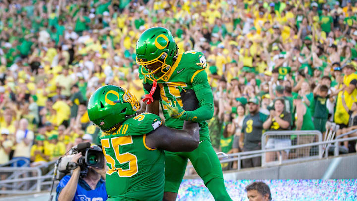 Oregon Ducks offensive lineman Marcus Harper II lifts Oregon Ducks wide receiver Tez Johnson into the air after a touchdown as the Oregon Ducks host the Idaho Vandals Saturday, Aug. 31, 2024 at Autzen Stadium in Eugene, Ore.