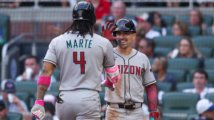 Jun 3, 2025; Atlanta, Georgia, USA; Arizona Diamondbacks second baseman Ketel Marte (4) celebrates with right fielder Corbin Carroll (7) after a two-run home run against the Atlanta Braves in the third inning at Truist Park. Mandatory Credit: Brett Davis-Imagn Images