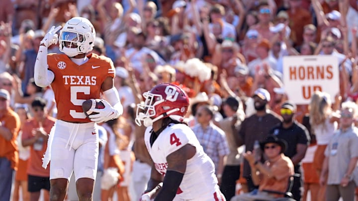 Texas Longhorns defensive back Malik Muhammad (5) celebrates an interception intended for Oklahoma Sooners wide receiver Deion Burks (4) in the first half of the Red River Rivalry college football game between the University of Oklahoma Sooners and the Texas Longhorn at the Cotton Bowl Stadium in Dallas, Texas, Saturday, Oct. 11, 2025.