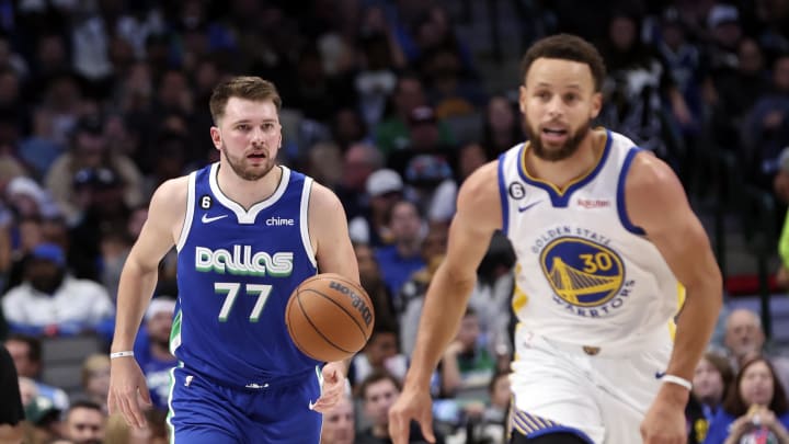 Nov 29, 2022; Dallas, Texas, USA;  Dallas Mavericks guard Luka Doncic (77) dribbles as Golden State Warriors guard Stephen Curry (30) runs upcourt during the second half at American Airlines Center. Mandatory Credit: Kevin Jairaj-USA TODAY Sports