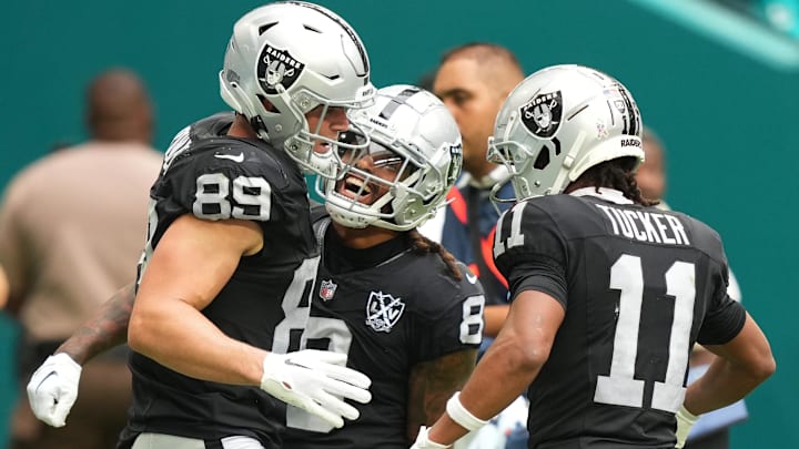 Nov 17, 2024; Miami Gardens, Florida, USA; Las Vegas Raiders tight end Brock Bowers (89) celebrates a touchdown in the third quarter with teammates running back Ameer Abdullah (8) and wide receiver Tre Tucker (11) at Hard Rock Stadium. Mandatory Credit: Jim Rassol-Imagn Images Nov 17, 2024; Miami Gardens, Florida, USA; Las Vegas Raiders tight end Brock Bowers (89) celebrates a touchdown in the third quarter with teammates running back Ameer Abdullah (8) and wide receiver Tre Tucker (11) at Hard Rock Stadium. Mandatory Credit: Jim Rassol-Imagn Images
