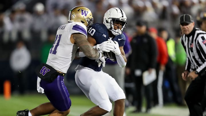 Penn State Nittany Lions running back Nicholas Singleton runs with the ball before being pushed out of bounds by Washington Huskies linebacker Alphonzo Tuputala (11) during the second quarter at Beaver Stadium. Penn State Nittany Lions running back Nicholas Singleton runs with the ball before being pushed out of bounds by Washington Huskies linebacker Alphonzo Tuputala (11) during the second quarter at Beaver Stadium.