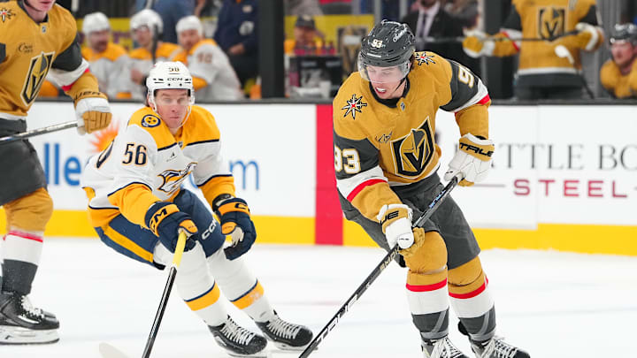 Jan 17, 2026; Las Vegas, Nevada, USA; Vegas Golden Knights right wing Mitch Marner (93) controls the puck ahead of Nashville Predators left wing Erik Haula (56) during the first period at T-Mobile Arena. Mandatory Credit: Stephen R. Sylvanie-Imagn Images
