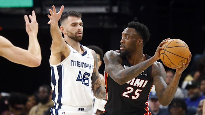 Oct 18, 2024; Memphis, Tennessee, USA; Miami Heat forward Nassir Little (25) handles the ball as Memphis Grizzlies guard John Konchar (46) defends during the second half at FedExForum. Mandatory Credit: Petre Thomas-Imagn Images