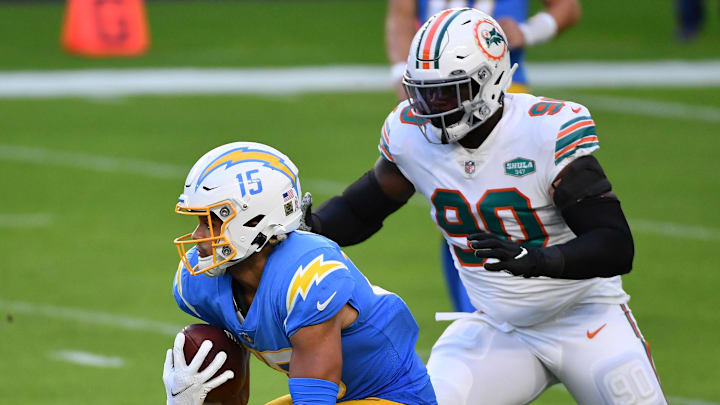 Miami Dolphins defensive end Shaq Lawson (90) chases Los Angeles Chargers wide receiver Jalen Guyton (15) during the first half at Hard Rock Stadium in a 2020 game. Miami Dolphins defensive end Shaq Lawson (90) chases Los Angeles Chargers wide receiver Jalen Guyton (15) during the first half at Hard Rock Stadium in a 2020 game.