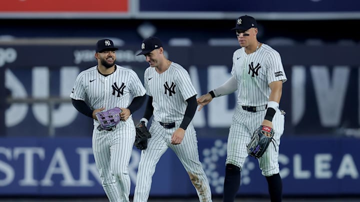 Jul 8, 2025; Bronx, New York, USA; New York Yankees left fielder Jasson Dominguez (24) and center fielder Cody Bellinger (35) and right fielder Aaron Judge (99) celebrate after defeating the Seattle Mariners at Yankee Stadium. Mandatory Credit: Brad Penner-Imagn Images