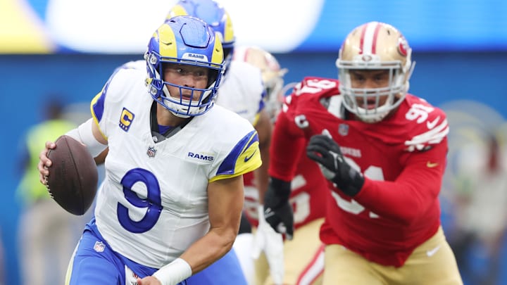 Los Angeles Rams quarterback Matthew Stafford (9) evades San Francisco 49ers defensive tackle Arik Armstead (91)