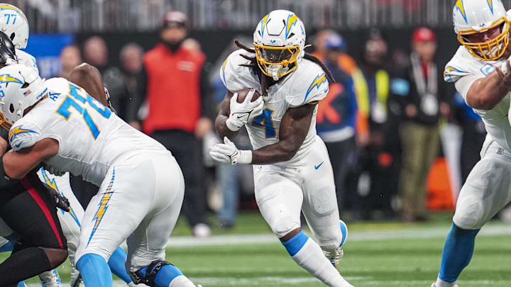 Former Los Angeles Chargers running back Gus Edwards (4) runs against the Atlanta Falcons during the first half at Mercedes-Benz Stadium. 