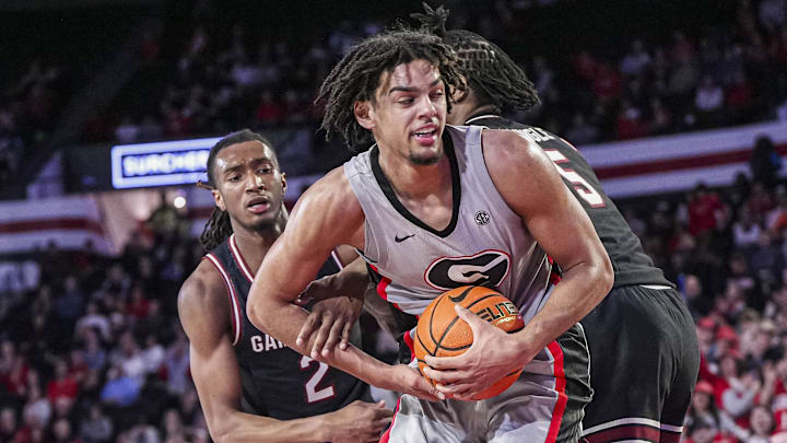 Jan 28, 2025; Athens, Georgia, USA; Georgia Bulldogs forward Asa Newell (14) grabs a rebound between South Carolina Gamecocks guard Zachary Davis (2) and forward Nick Pringle (5) during the second half at Stegeman Coliseum. Mandatory Credit: Dale Zanine-Imagn Images