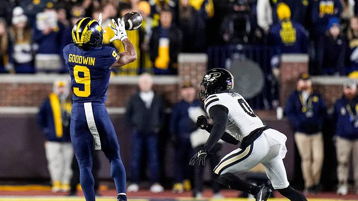 Michigan wide receiver Channing Goodwin (9) makes a catch against Purdue defensive back Tony Grimes (0) during the second half at Michigan Stadium in Ann Arbor on Saturday, November 1, 2025. Michigan wide receiver Channing Goodwin (9) makes a catch against Purdue defensive back Tony Grimes (0) during the second half at Michigan Stadium in Ann Arbor on Saturday, November 1, 2025.
