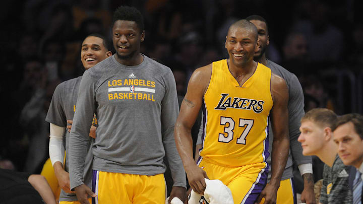 April 11, 2017; Los Angeles, CA, USA; Los Angeles Lakers forward Metta World Peace (37) reacts with forward Julius Randle (30) after coming to the bench against the New Orleans Pelicans during the second half at Staples Center. Mandatory Credit: Gary A. Vasquez-Imagn Images