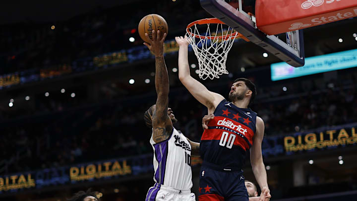 Apr 2, 2025; Washington, District of Columbia, USA; Washington Wizards forward Tristan Vukcevic (00) blocks the shot of Sacramento Kings forward DeMar DeRozan (10) in the first half at Capital One Arena. Mandatory Credit: Geoff Burke-Imagn Images