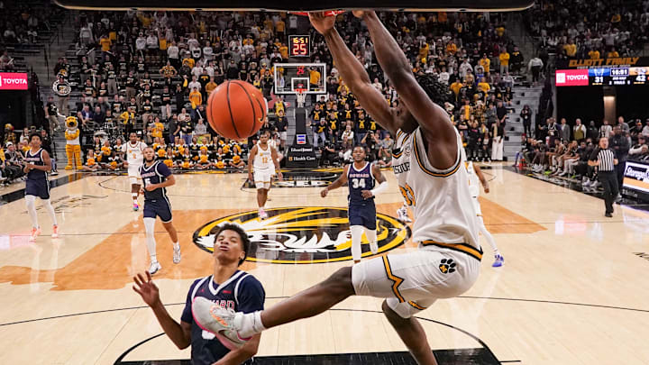 Nov 8, 2024; Columbia, Missouri, USA; Missouri Tigers center Josh Gray (33) dunks the ball as Howard Bison guard Blake Harper (7) looks on during the second half at Mizzou Arena. Mandatory Credit: Denny Medley-Imagn Images