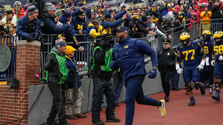 Michigan Wolverines head coach Sherrone Moore leads his team onto the field for warm ups during the NCAA football game against the Ohio State Buckeyes at Michigan Stadium in Ann Arbor, Mich. on Nov. 29, 2025. Ohio State won 27-9. Michigan Wolverines head coach Sherrone Moore leads his team onto the field for warm ups during the NCAA football game against the Ohio State Buckeyes at Michigan Stadium in Ann Arbor, Mich. on Nov. 29, 2025. Ohio State won 27-9.