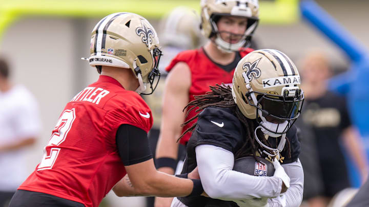Jun 10, 2025; New Orleans, LA, USA;  New Orleans Saints quarterback Spencer Rattler (2) hands the ball off to running back Alvin Kamara (41) during minicamp at Ochsner Sports Performance Center. Mandatory Credit: Stephen Lew-Imagn Images