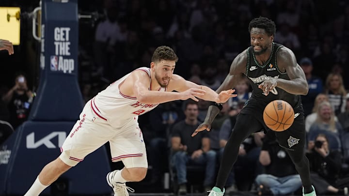 Mar 25, 2026; Minneapolis, Minnesota, USA; Houston Rockets center Alperen Sengun (28) challenges Minnesota Timberwolves forward Julius Randle (30) for the ball in the fourth quarter at Target Center. Mandatory Credit: Bruce Kluckhohn-Imagn Images