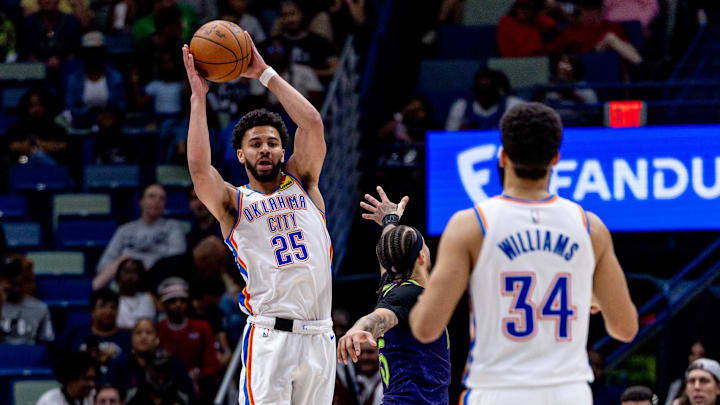 Apr 13, 2025; New Orleans, Louisiana, USA;  Oklahoma City Thunder guard Ajay Mitchell (25) passes the ball to forward Kenrich Williams (34) over New Orleans Pelicans guard Jose Alvarado (15) during the second half at Smoothie King Center. Mandatory Credit: Stephen Lew-Imagn Images