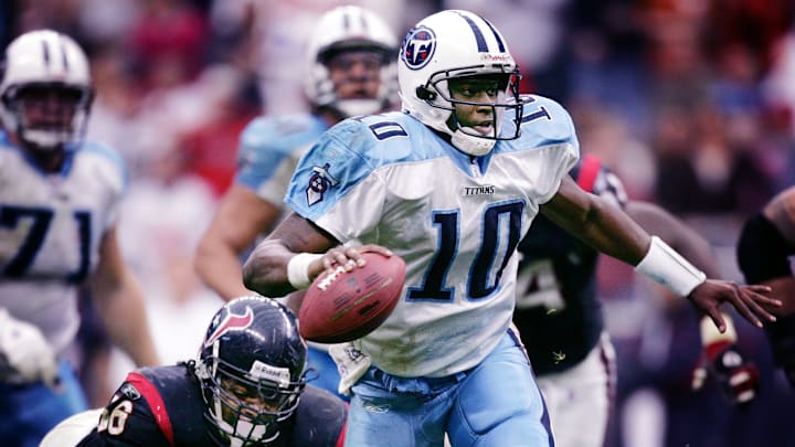 Tennessee Titans rookie quarterback Vince Young (10) breaks away from Houston Texans linebacker Morlon Greenwood (56) to score the game winning touchdown on a 39-yard run in overtime at Reliant Stadium in Houston, Texas, on Dec. 10, 2006.