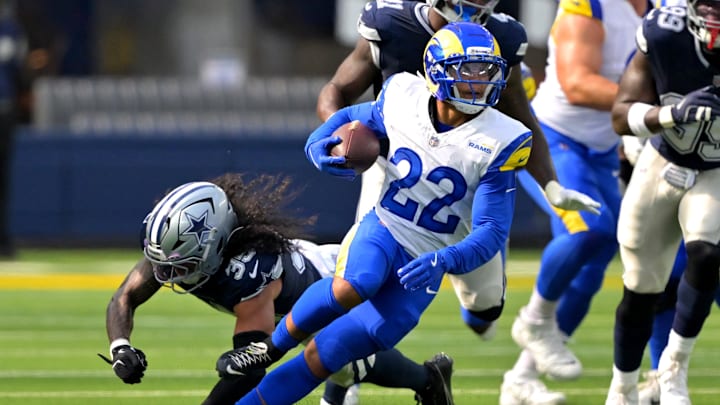 Aug 9, 2025; Inglewood, California, USA;  Los Angeles Rams running back Blake Corum (22) runs past Dallas Cowboys linebacker Marist Liufau (35) for a first down during the first half at SoFi Stadium. Mandatory Credit: Jayne Kamin-Oncea-Imagn Images