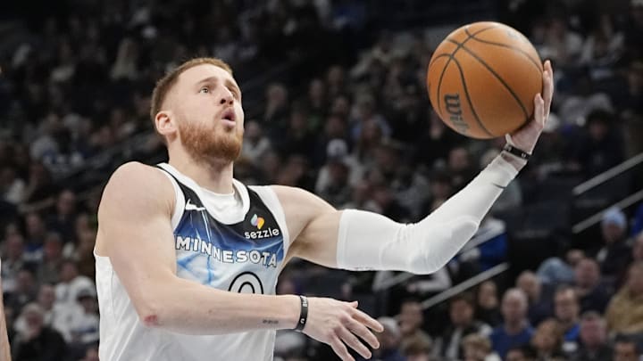 Apr 11, 2025; Minneapolis, Minnesota, USA; Minnesota Timberwolves guard Donte DiVincenzo (0) goes to the basket against the Brooklyn Nets in the fourth quarter at Target Center. Mandatory Credit: Bruce Kluckhohn-Imagn Images