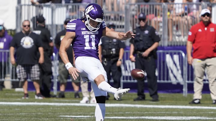Aug 31, 2024; Evanston, Illinois, USA; Northwestern Wildcats punter Luke Akers (11) punts against the Miami (Oh) Redhawks during the first half at Lanny and Sharon Martin Stadium.