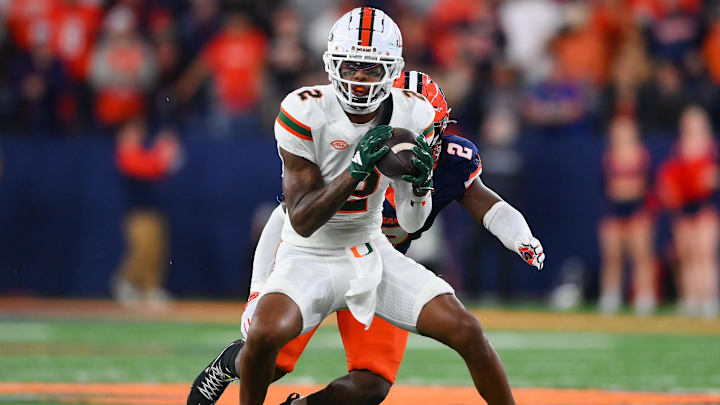 Nov 30, 2024; Syracuse, New York, USA; Miami Hurricanes wide receiver Isaiah Horton (2) catches the ball against Syracuse Orange linebacker Marlowe Wax (2) during the second half at the JMA Wireless Dome. Mandatory Credit: Rich Barnes-Imagn Images