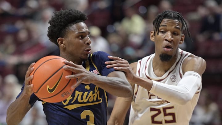 Feb 4, 2025; Tallahassee, Florida, USA; Notre Dame Fighting Irish guard Markus Burton (3) past Florida State Seminoles guard Justin Thomas (25) during the first half at Donald L. Tucker Center. Mandatory Credit: Melina Myers-Imagn Images