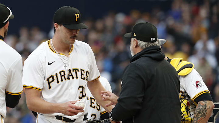 Pittsburgh Pirates starting pitcher Paul Skenes (30) surrenders the ball to manager Derek Shelton (right) as he is removed from the game against the Chicago Cubs during the fifth inning at PNC Park. 
