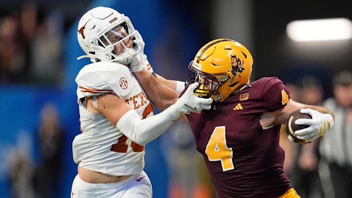 Jan 1, 2025; Atlanta, GA, USA; Arizona State Sun Devils running back Cam Skattebo (4) and Texas Longhorns defensive back Michael Taaffe (16) push each other during the second half of the Peach Bowl at Mercedes-Benz Stadium. Mandatory Credit: Dale Zanine-Imagn Images