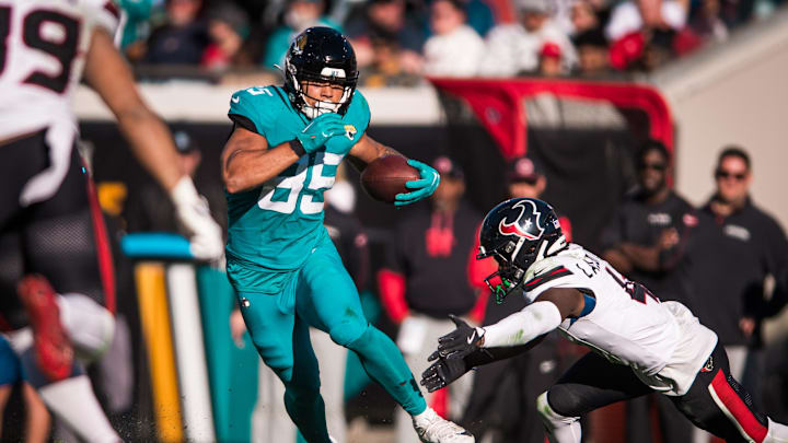 Dec 1, 2024; Jacksonville, Florida, USA; Jacksonville Jaguars tight end Brenton Strange (85) runs after the catch against Houston Texans cornerback Kamari Lassiter (4) in the third quarter  at EverBank Stadium. 