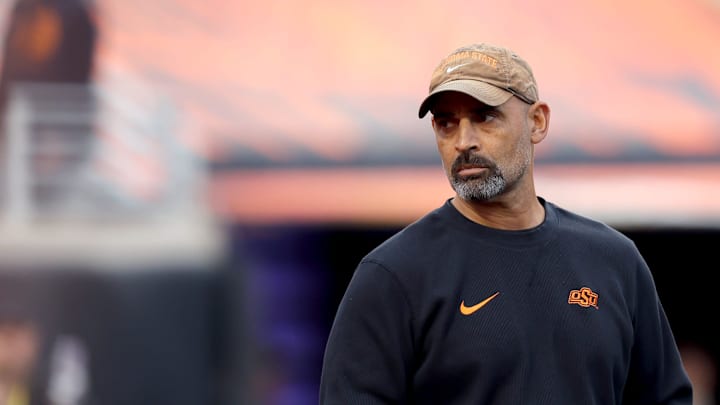 Oklahoma State's Kasey Dunn,Associate Head Coach/Offensive Coordinator/Receivers, watches players warm up before the college football game between the Oklahoma State University Cowboys and the Kansas State Wildcats at Boone Pickens Stadium in Stillwater. Okla., Friday, Oct. 6, 2023. Oklahoma State's Kasey Dunn,Associate Head Coach/Offensive Coordinator/Receivers, watches players warm up before the college football game between the Oklahoma State University Cowboys and the Kansas State Wildcats at Boone Pickens Stadium in Stillwater. Okla., Friday, Oct. 6, 2023.
