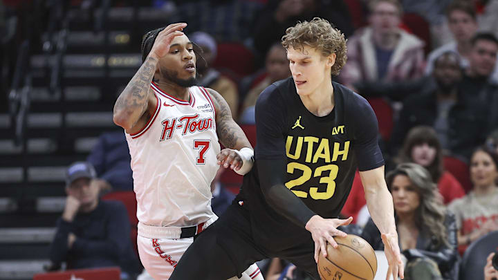Jan 20, 2024; Houston, Texas, USA; Utah Jazz forward Lauri Markkanen (23) controls the ball as Houston Rockets forward Cam Whitmore (7) defends during overtime at Toyota Center. Mandatory Credit: Troy Taormina-Imagn Images