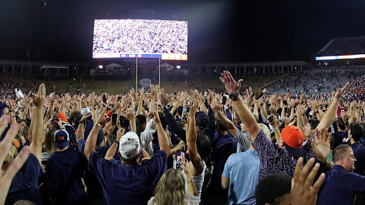 Sep 26, 2025; Charlottesville, Virginia, USA; Virginia Cavaliers fans and players celebrate on the field after their game against the Florida State Seminoles at Scott Stadium. Mandatory Credit: Geoff Burke-Imagn Images Sep 26, 2025; Charlottesville, Virginia, USA; Virginia Cavaliers fans and players celebrate on the field after their game against the Florida State Seminoles at Scott Stadium. Mandatory Credit: Geoff Burke-Imagn Images
