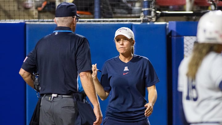 Jun 3, 2022; Oklahoma City, Oklahoma, USA;  Arizona Wildcats head coach Caitlin Lowe talks to an umpire during the fifth inning of the NCAA Women's College World Series game against the Oregon State Beavers at USA Softball Hall of Fame Stadium. Arizona won 3-1. Mandatory Credit: Brett Rojo-Imagn Images
