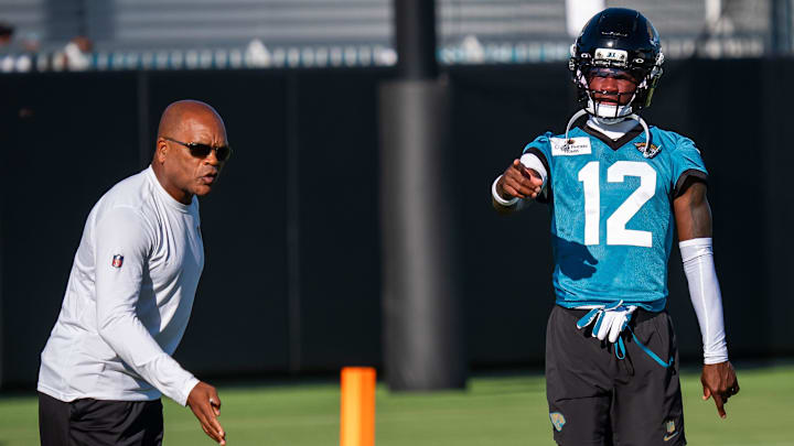 Jacksonville Jaguars wide receiver Travis Hunter (12) talks with Jaguars Secondary Coach Ron Milus during an NFL training camp second session at the Miller Electric Center, Thursday, July 24, 2025, in Jacksonville, Fla. [Doug Engle/Florida Times-Union]