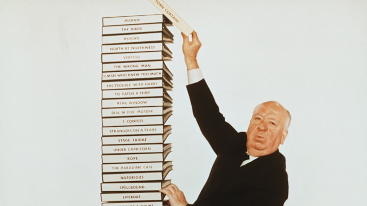 Alfred Hitchcock and a Stack of His Scripts
