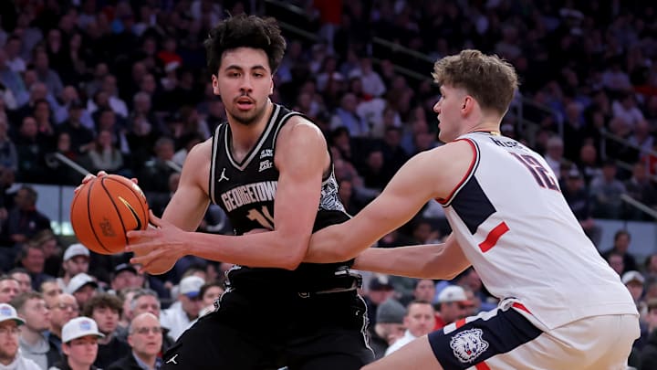Mar 13, 2026; New York, NY, USA; Georgetown Hoyas center Julius Halaifonua (11) controls the ball against Connecticut Huskies center Eric Reibe (12) during the first half at Madison Square Garden. Mandatory Credit: Brad Penner-Imagn Images