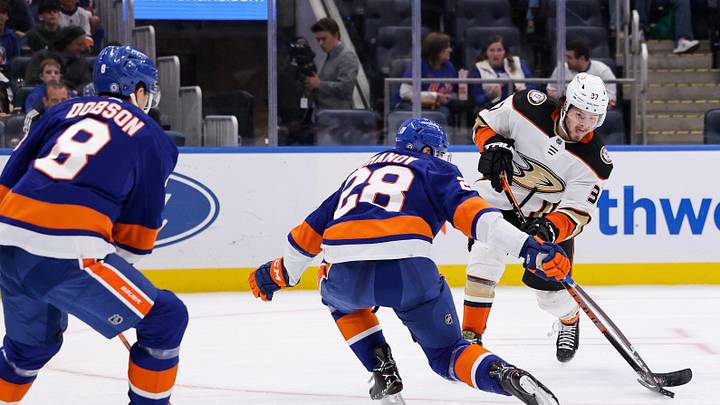 Oct 15, 2022; Elmont, New York, USA; New York Islanders defenseman Alexander Romanov (28) blocks a puck shot by Anaheim Ducks center Mason McTavish (37) during the first period of a game. Mandatory Credit: Jessica Alcheh-Imagn Images
