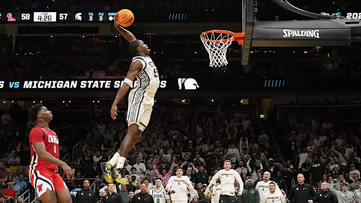 Mar 28, 2025; Atlanta, GA, USA; Michigan State Spartans forward Coen Carr (55) dunks against Mississippi Rebels forward Malik Dia (0) in the second half of a South Regional semifinal of the 2025 NCAA tournament at State Farm Arena. Mandatory Credit: Dale Zanine-Imagn Images Mar 28, 2025; Atlanta, GA, USA; Michigan State Spartans forward Coen Carr (55) dunks against Mississippi Rebels forward Malik Dia (0) in the second half of a South Regional semifinal of the 2025 NCAA tournament at State Farm Arena. Mandatory Credit: Dale Zanine-Imagn Images