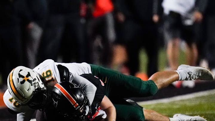St. Xavier Tigers linebacker Luka Benz (16) tackles Ryle Raiders running back Jacob Savage (21) in the second quarter of a high school football game between the Ryle Raiders and St. Xavier Tigers, Friday, Nov. 15, 2024, at Clifford R. Borland, Sr. Stadium in Union, Ky.
