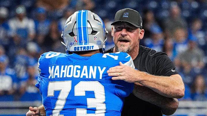 Detroit Lions head coach Dan Campbell hugs guard Christian Mahogany (73) during warm up at Ford Field in Detroit on Sunday, Sept. 14, 2025.