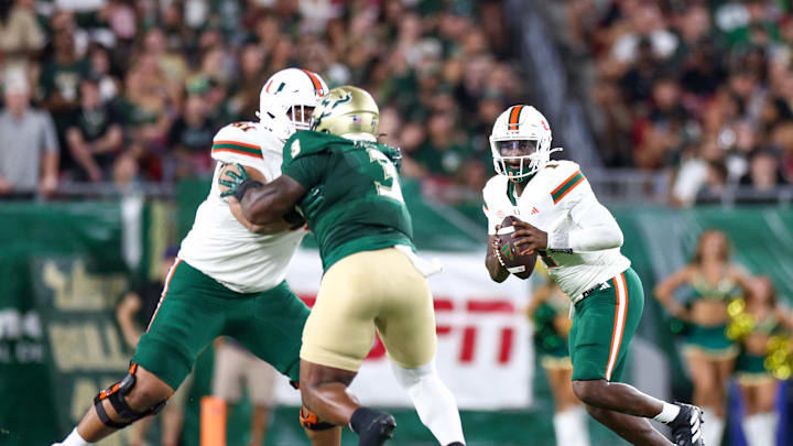 Sep 21, 2024; Tampa, Florida, USA; Miami Hurricanes quarterback Cam Ward (1) drops back to pass against the South Florida Bulls in the second quarter at Raymond James Stadium. Mandatory Credit: Nathan Ray Seebeck-Imagn Images